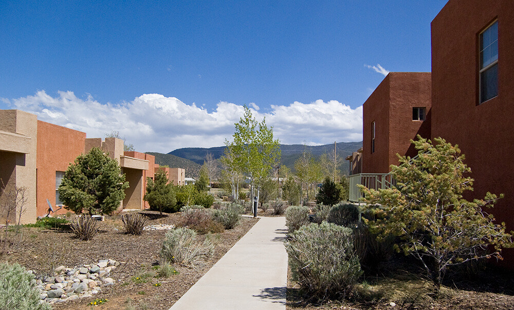 Long walkway between Tierra Montosa homes leading toward the mountains south of Taos